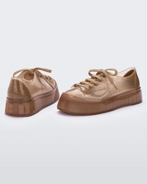 Back and side view of a clear beige Drive Sneaker