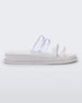 Side view of a white/clear Melissa Soft Wave Slide with 4 straps: two clear and two white.