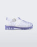 Side view of a clear Mini Melissa Possession sandal with several straps and a closed toe front.