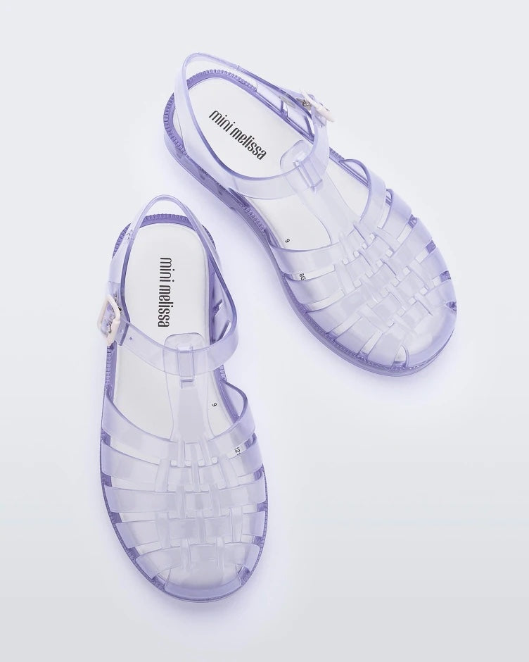 A top view of a pair of clear Mini Melissa Possession sandals with several straps and a clear base.