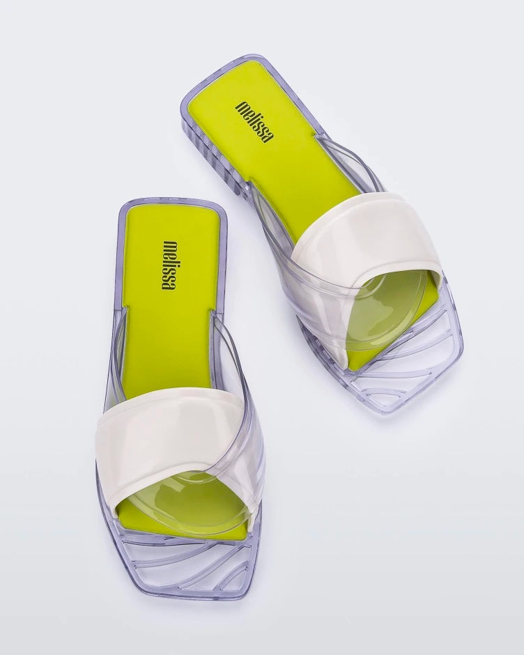 Top view of a pair of white/clear/yellow Melissa Brigitte slides with a white weft designed upper strap, clear lower strap and yellow insole.