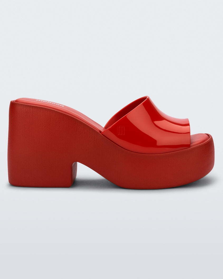 Side view of the Melissa Posh platform slide in Red