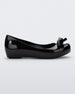 Side view of a Black Mini Melissa Ultragirl Bow flat with a black base and bow.