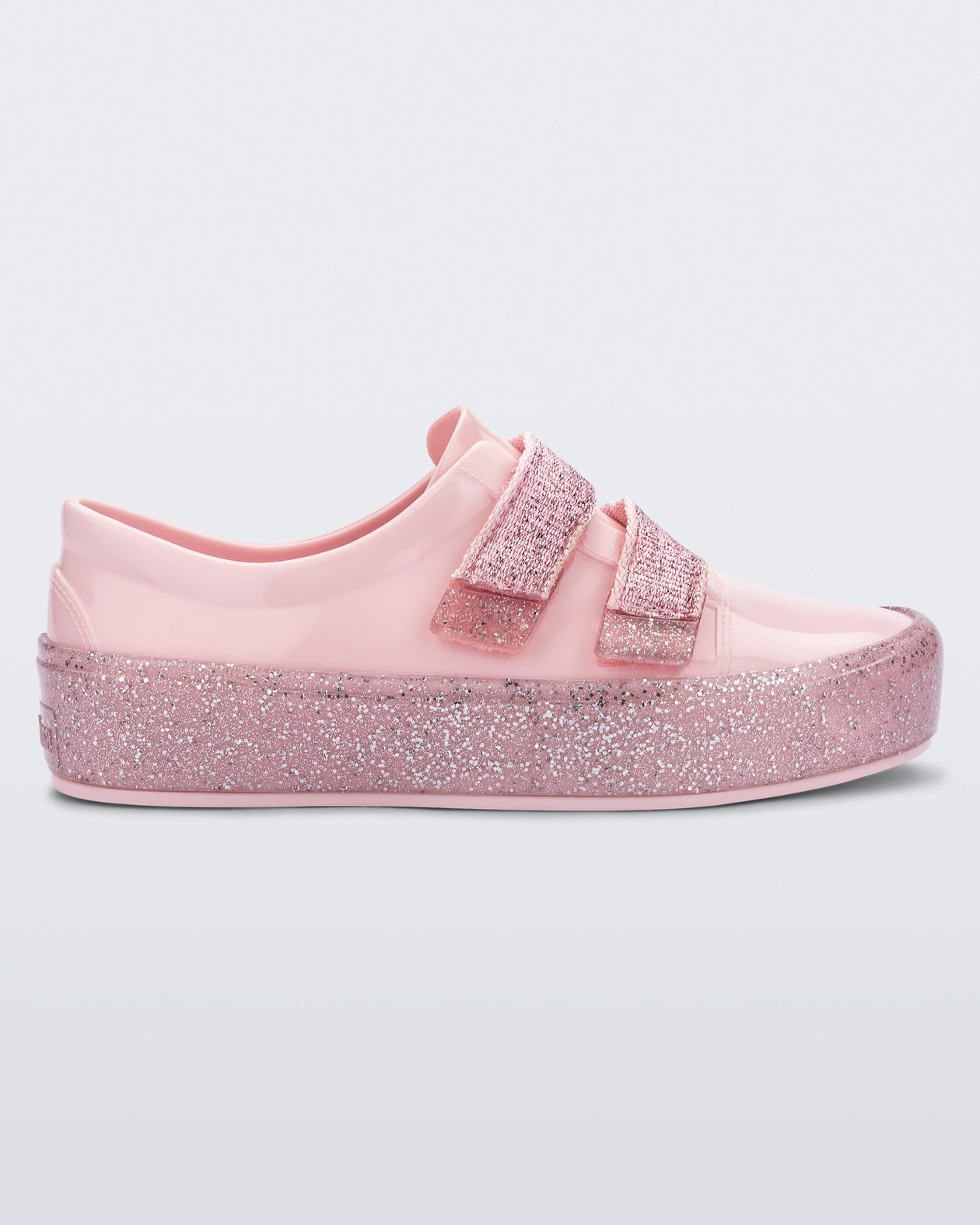 Side view of a Pink/Pink Glitter Mini Melissa Beanny Bugs sneaker with a pink base, two shiny pink velcro straps and a pink glitter sole.