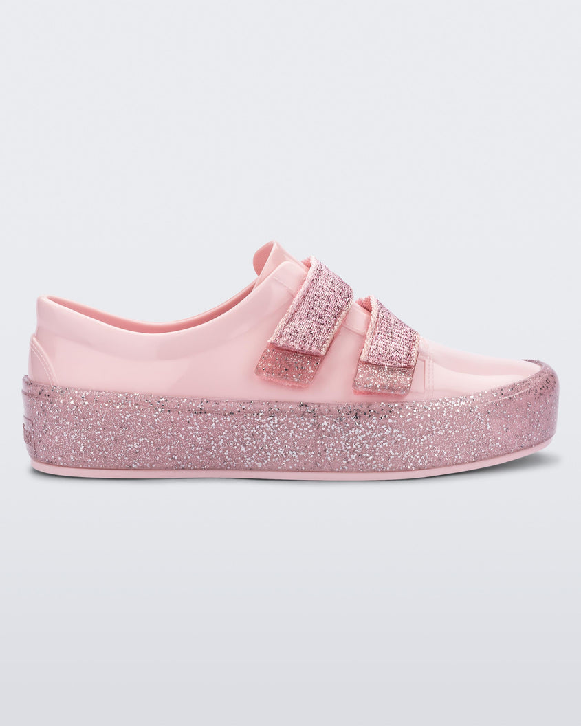 Side view of a Pink/Pink Glitter Mini Melissa Beanny Bugs sneaker with a pink base, two shiny pink velcro straps and a pink glitter sole.