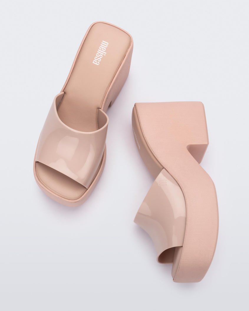 Top view and side view of a pair of Melissa Posh platform slides in Pink