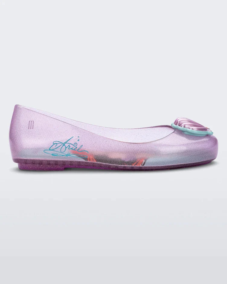 Side view of a purple Mini Melissa Sweet Love Princess flat, with a purple base, Ariel in script on the side, a sea shell detail on the toe, and a drawing of Ariel of The Little Mermaid on the sole.