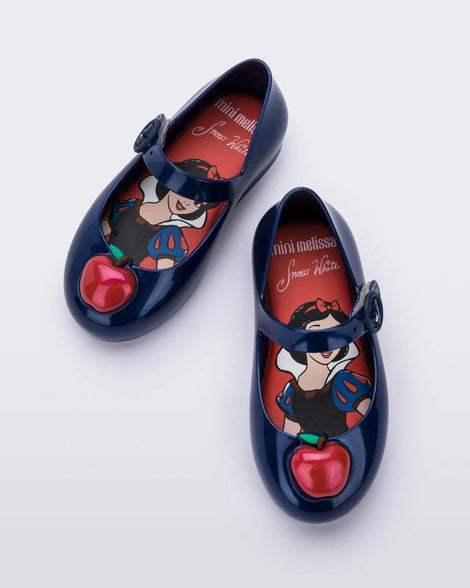 Top view of a pair of Metallic Blue/Red Mini Melissa Sweet Love Princess flats with a metallic blue base, a top strap, Snow White in script on the side, an apple detail on the toe, and a drawing of Snow White on the sole.