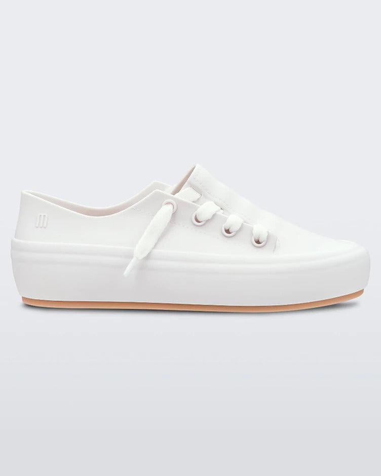 An outter side view of a white/beige Melissa Ulitsa sneaker with a white base, laces and a beige sole.