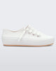 An outter side view of a white/beige Melissa Ulitsa sneaker with a white base, laces and a beige sole.