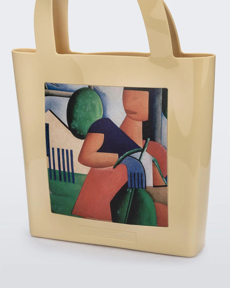 An Adult Melissa Canvas + Tarsila Do Amaral Bag with a painting of a woman holding a child.
