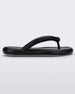 Side view of a black Melissa Free Flip Flop with puffer-like straps.