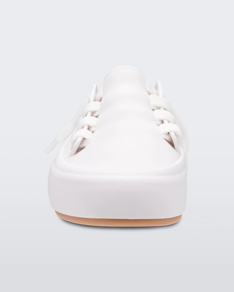 Front view of a white/beige Melissa Ulitsa sneaker with a white base, laces and a beige sole.