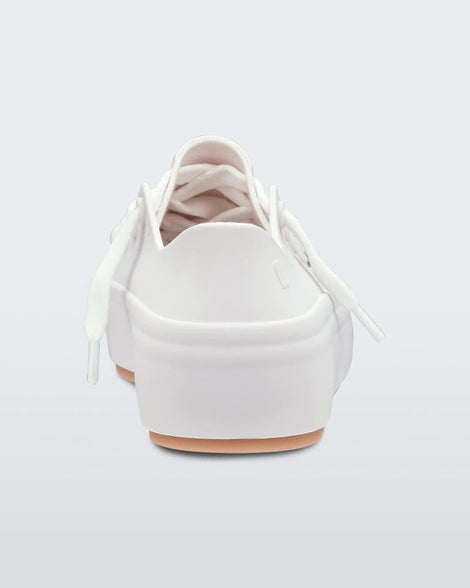 Back view of a white/beige Melissa Ulitsa sneaker with a white base, laces and a beige sole.