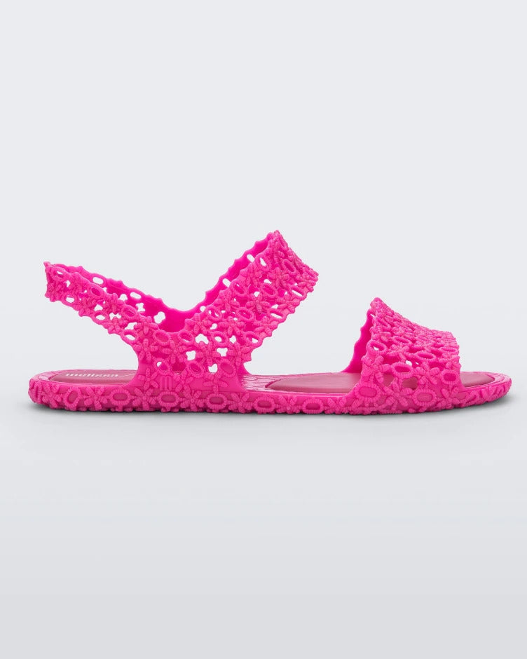 Side view of a pink Melissa Panc Sandal with a crochet pattern.