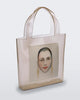 An Adult Melissa Canvas + Tarsila Do Amaral Bag with a picture of a woman's face on it.