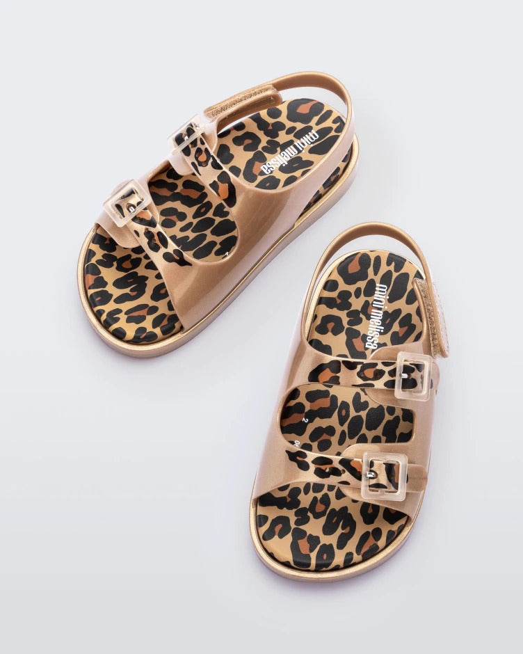 Top view of a pair of gold/brown Mini Melissa Wide Sandals with a gold base, cheetah print insole, cheetah print straps and two buckles on top.