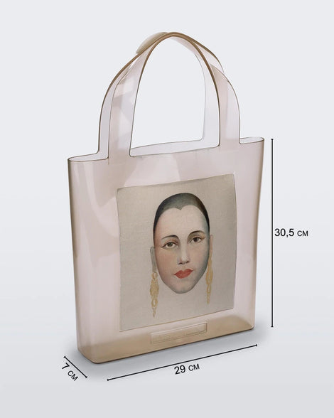 An Adult Melissa Canvas + Tarsila Do Amaral Bag with a picture of a woman's face on it.
