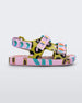 Side view of a lilac/blue Mini Melissa Ping Pong sandal with a pink, green, black and blue patterned base and pink patterned velcro straps.