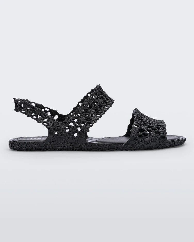 Side view of a pair of black Melissa Panc Sandals.