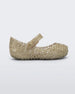 Side view of Mini Melissa Campana gold flats with a snap strap for baby.