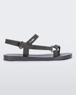 Side view of a graphite metallic Melissa Sun Downtown sandal with a front and ankle strap joined together by a vertical strap and a triangle buckle.