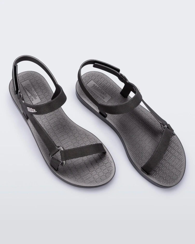 Top view of a pair of graphite metallic Melissa Sun Downtown sandals with a front and ankle strap joined together by a vertical strap and a triangle buckle.