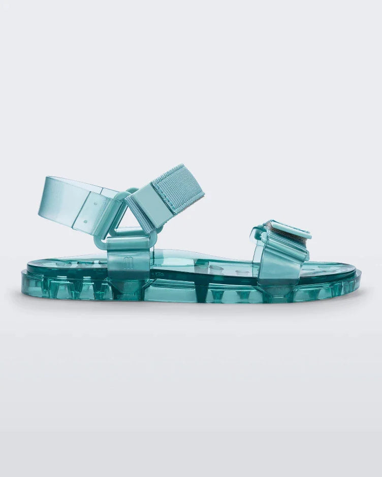 Side view of a Melissa Wide Papete sandals with transparent green sole and green velcro straps