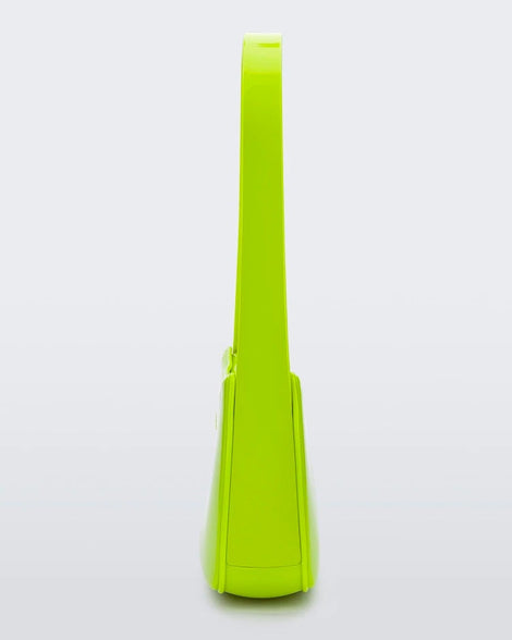 Side view of a neon green Melissa Baguete handbag.