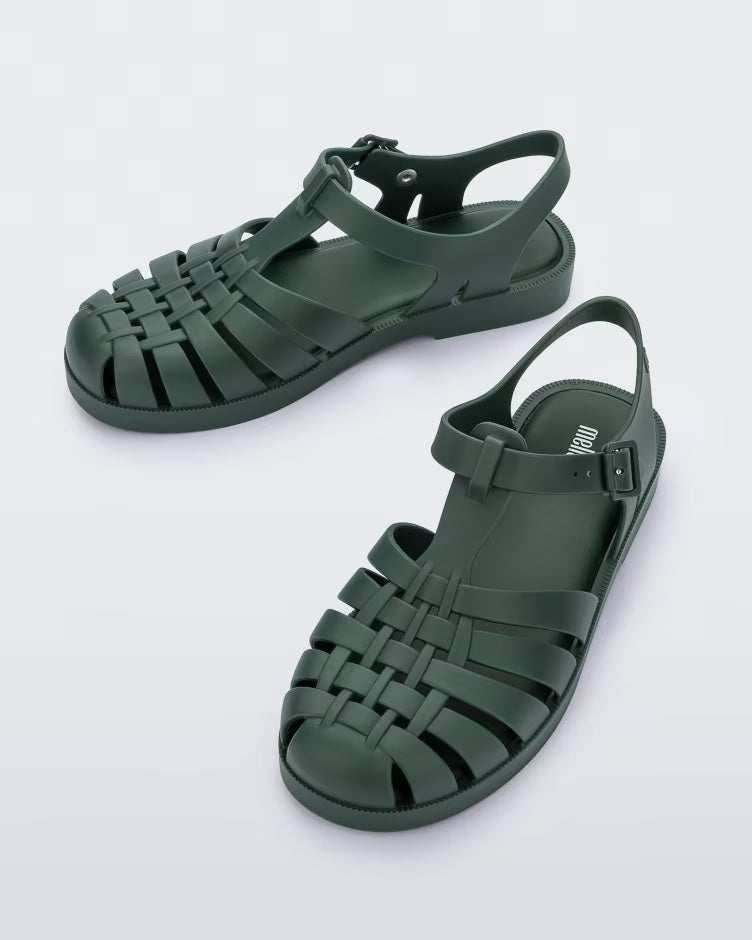 A top view of a pair of dark green Melissa Possession sandals with several straps and a closed toe front.
