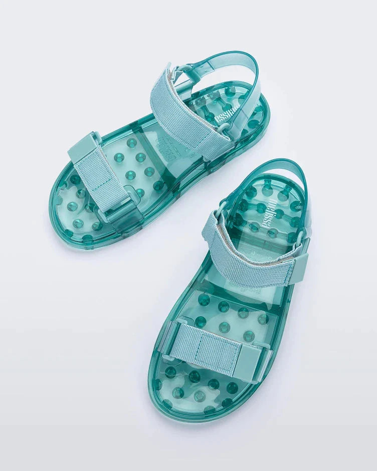 Top view of a pair of Melissa Wide Papete sandals with transparent green sole and green velcro straps