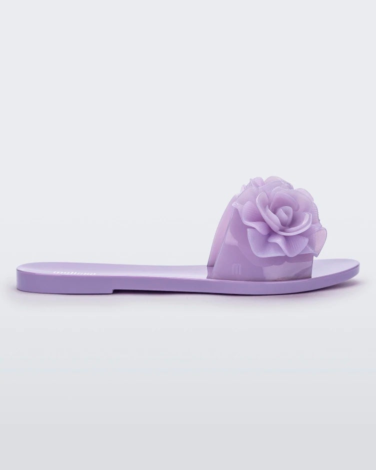 Side view of a lilac Melissa Babe Garden slide with two flowers on the front strap.