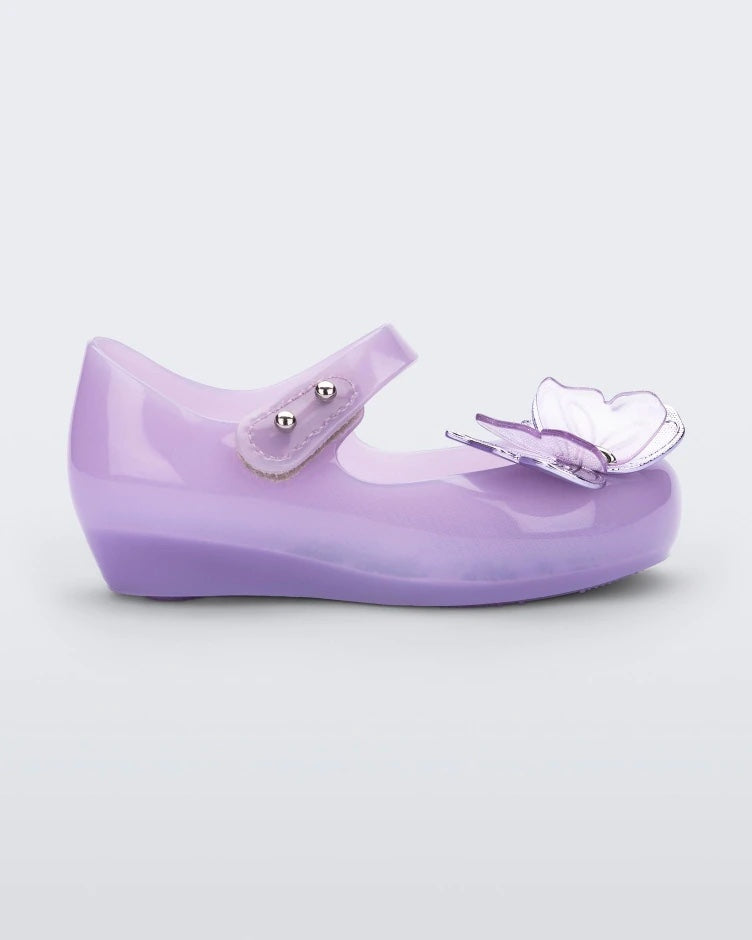 Side view of a lilac Mini Melissa Ultragirl Butterfly flat with a top strap and two butterfly details on the toe.