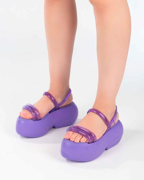 A model's legs wearing lilac Melissa Airbubble Platform sandals