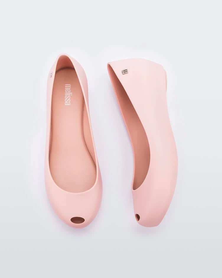 A top and side view of a pair of light pink Melissa Ultragirl Basic flats