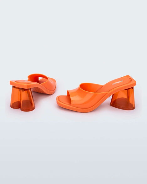 Side and back view of a pair of orange Candy heels