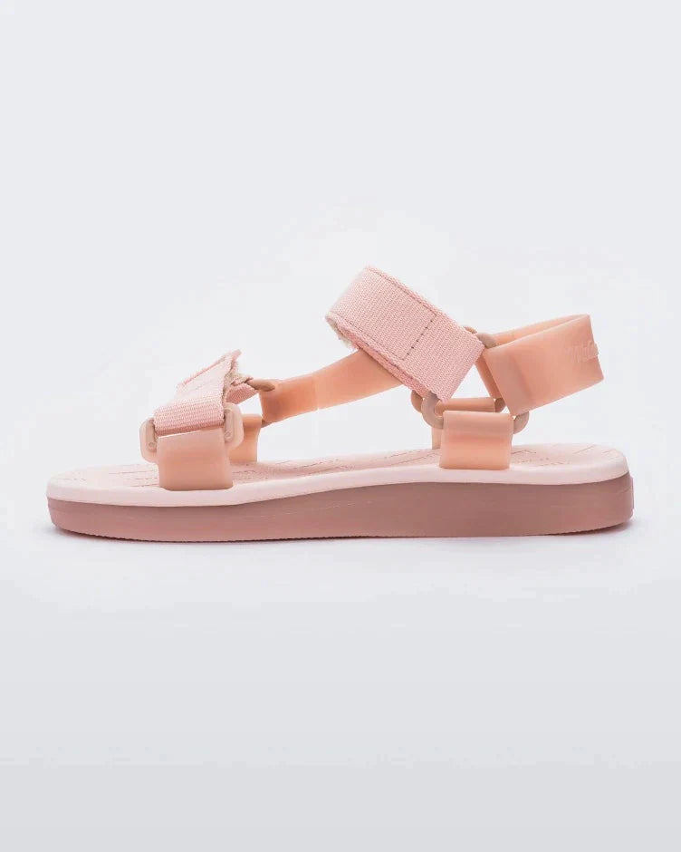 Side view of a pair of pink Melissa Papete sandals.
