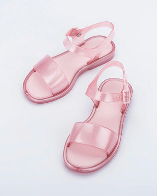 Angled view of a pair of pink glitter Mini Melissa Mar Sandals.
