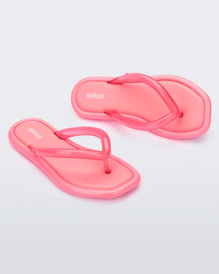 Angled view of a pair of pink Melissa Airbubble Flip Flops.