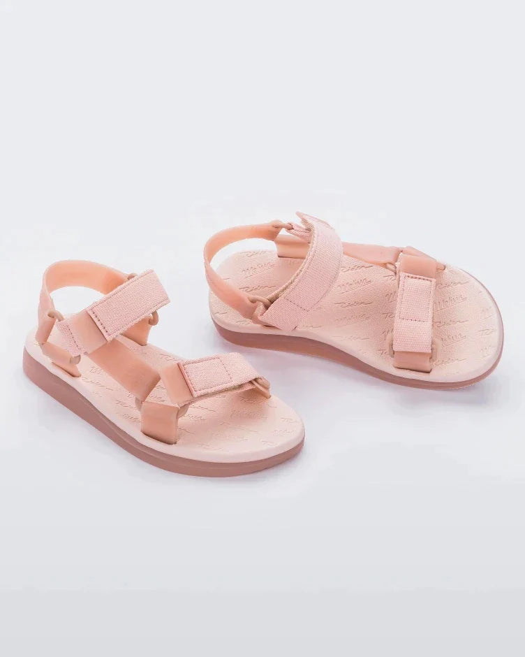 Angled view of a pair of pink Melissa Papete sandals.