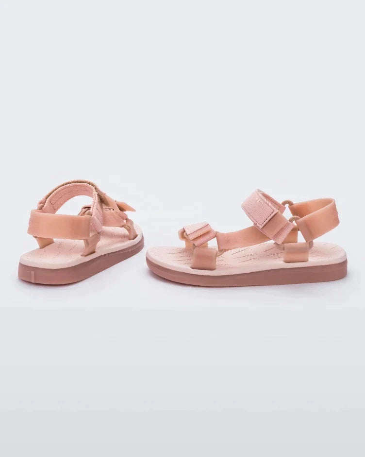 Side and back view of a pair of pink Melissa Papete sandals.