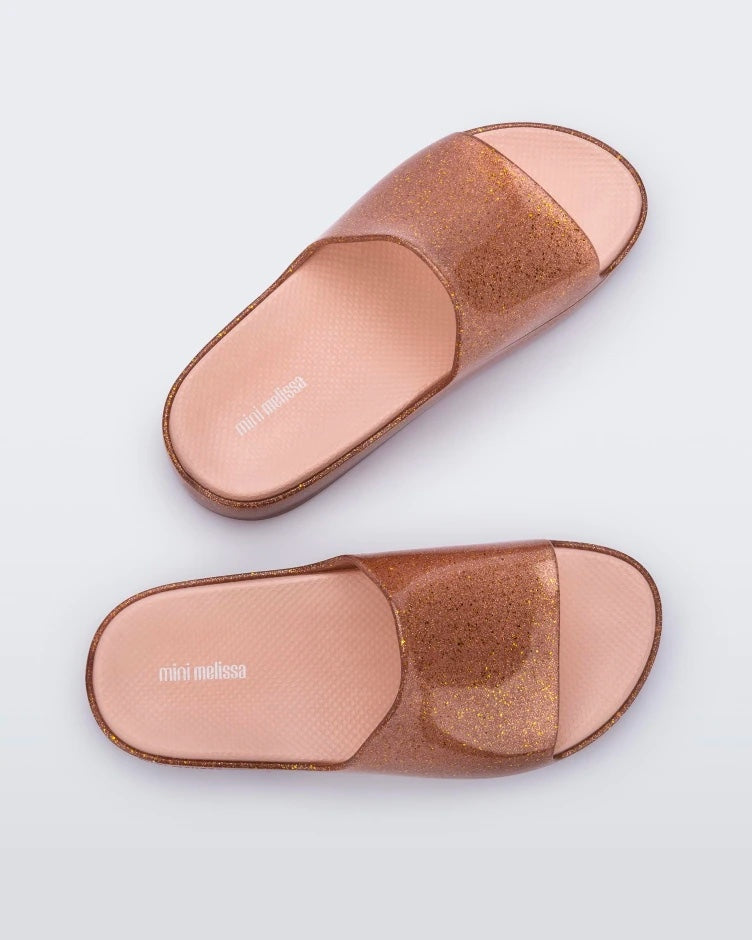 Top view of a pair of pink glitter Mini Melissa Cloud slides.