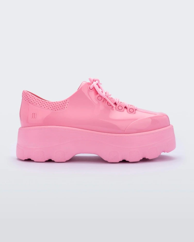 Side view of a solid pink platform Melissa Kick Off Sneaker with laces.