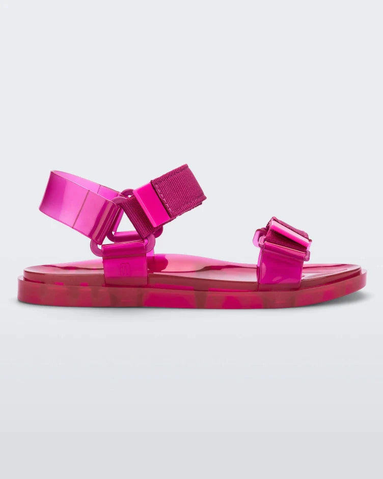 Side view of a Melissa Wide Papete sandal in pink with velcro ankle and front straps.