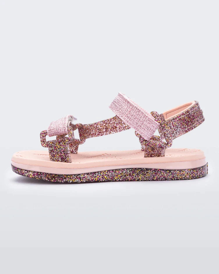 Side view of pink and glitter Mini Melissa Papete sandal.