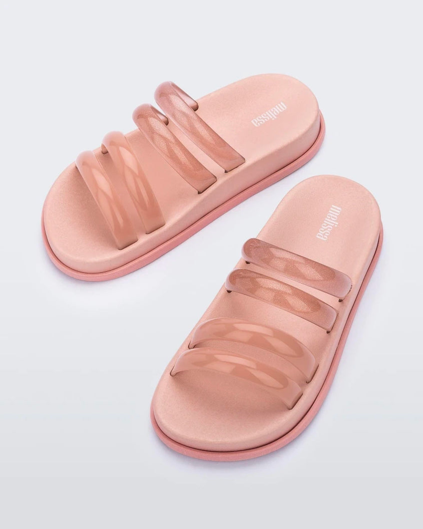Top view of a pair of pink/clear pink Melissa Soft Wave Slides with 4 straps: two pink and two clear pink.