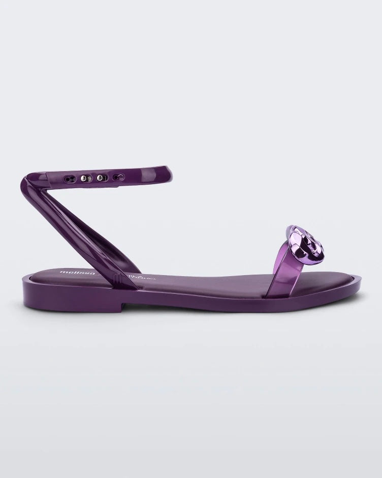 Side view of a purple Melissa Dare sandal with a purple metal chain buckle.