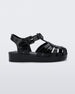 An outter side view of a black Mini Melissa Possession sandal with several straps with a closed toe front.