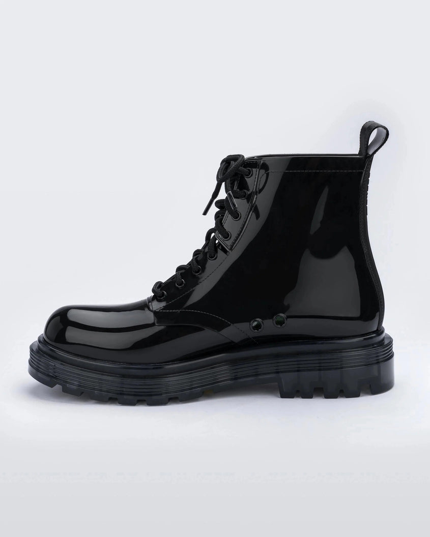 An inner side view of a pair of black Melissa Coturno boot with a black base, laces and sole.