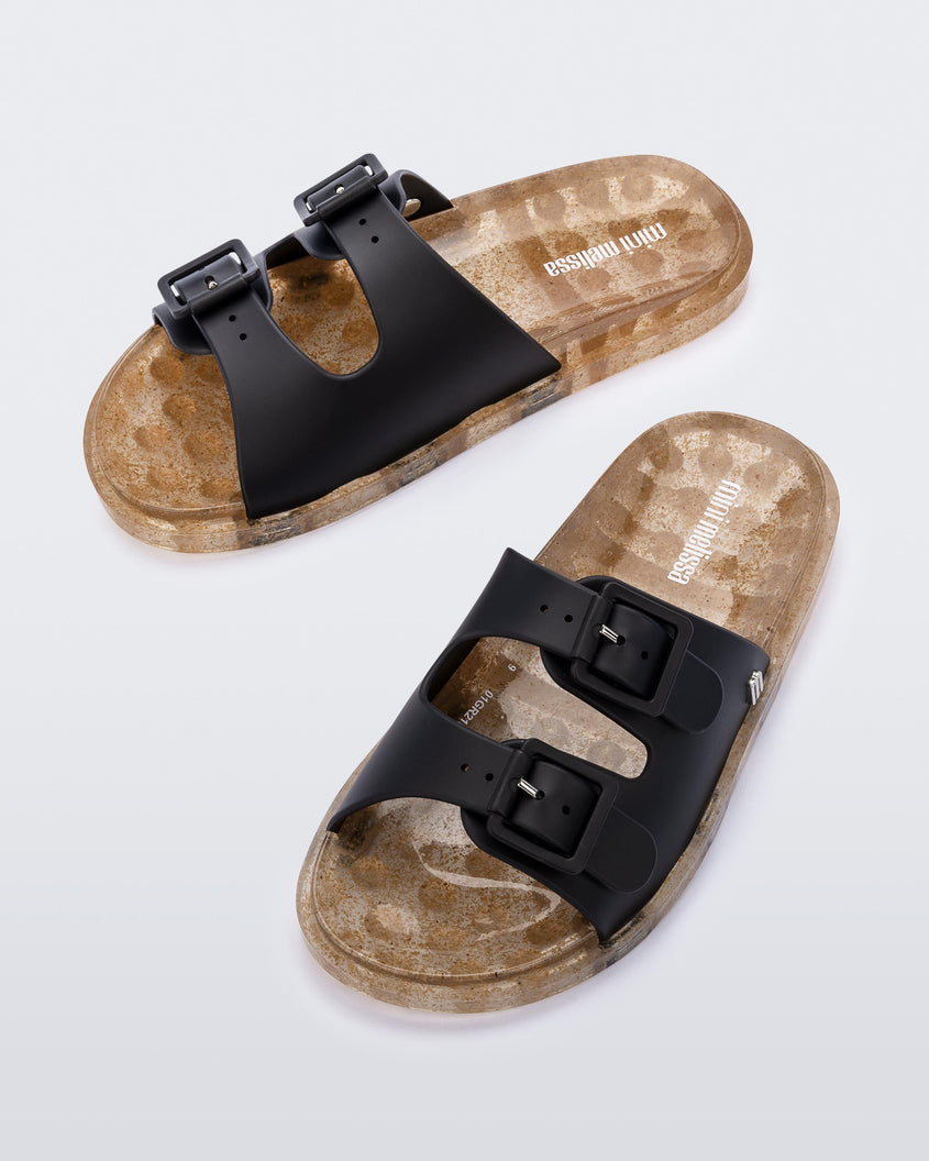 Top view of a pair of Black/Beige Mini Melissa Wide Slides with a black top with two black buckles and a beige sole.